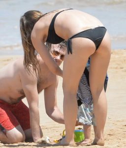 Olivia Wilde in a Black Bikini at the Beach in Hawaii 04/22/2016-5