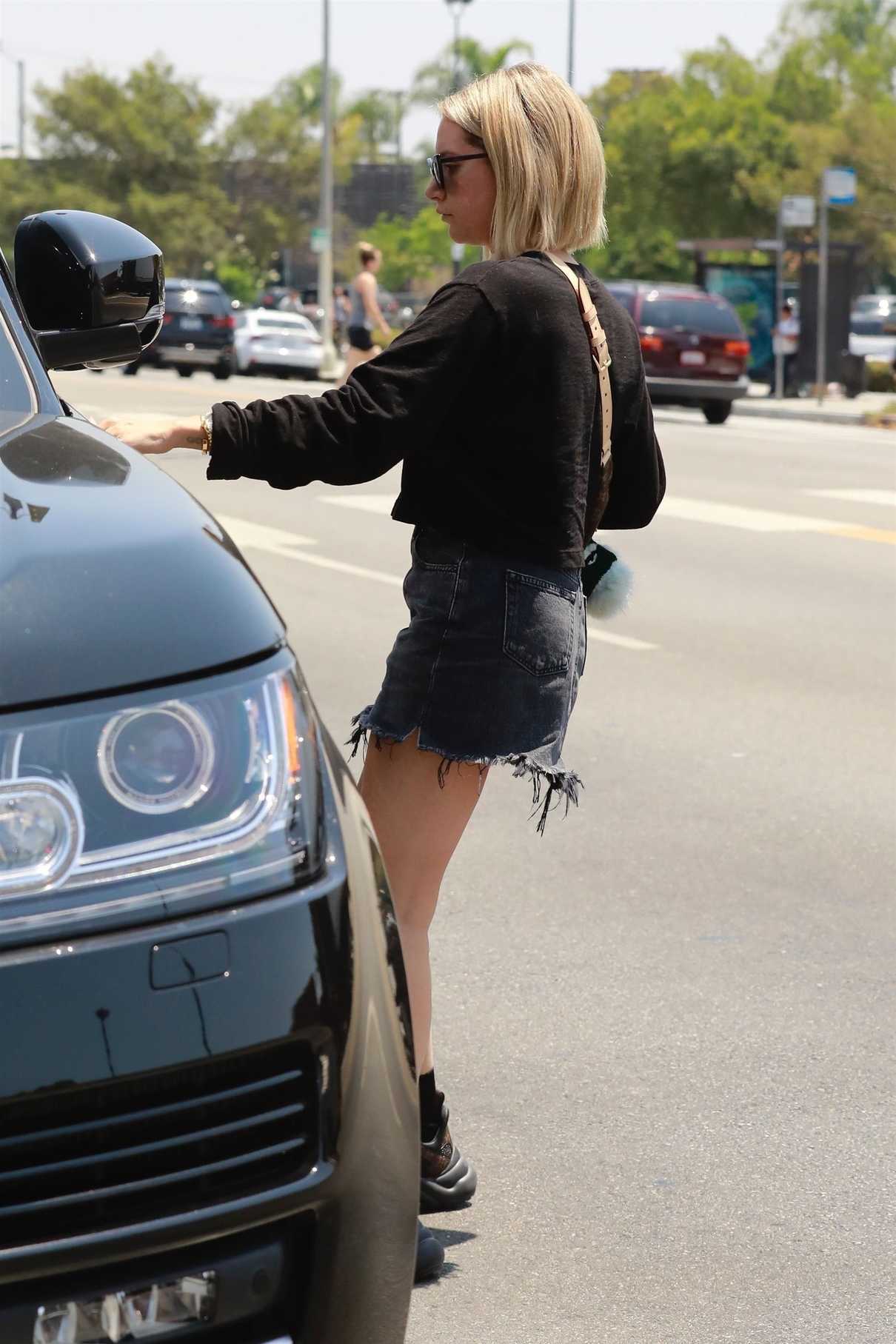 Ashley Tisdale in a Short Ripped Denim Skirt