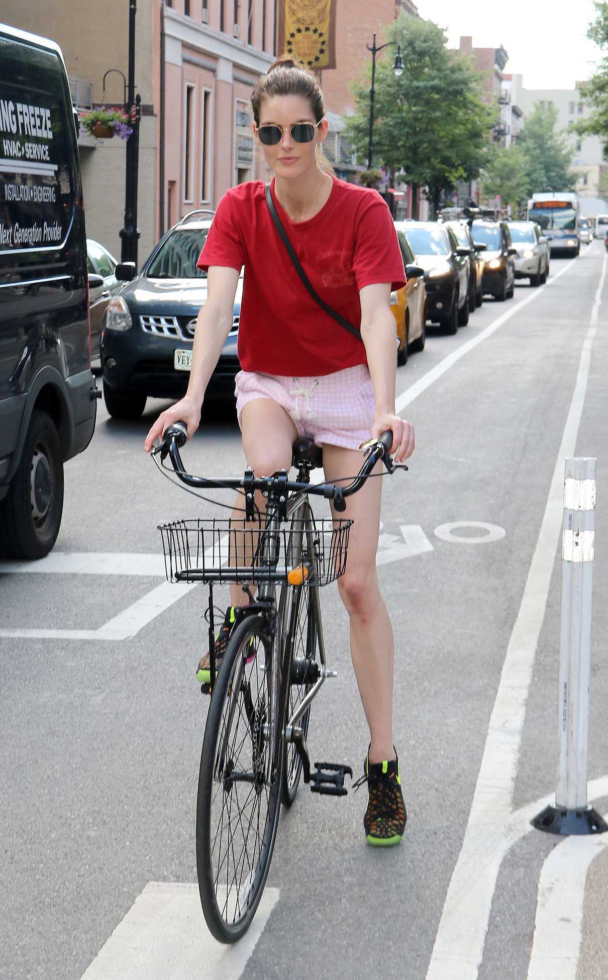 Hilary Rhoda in a Red T-Shirt Rides Her Bicycle in New York City 07/18/2018-2