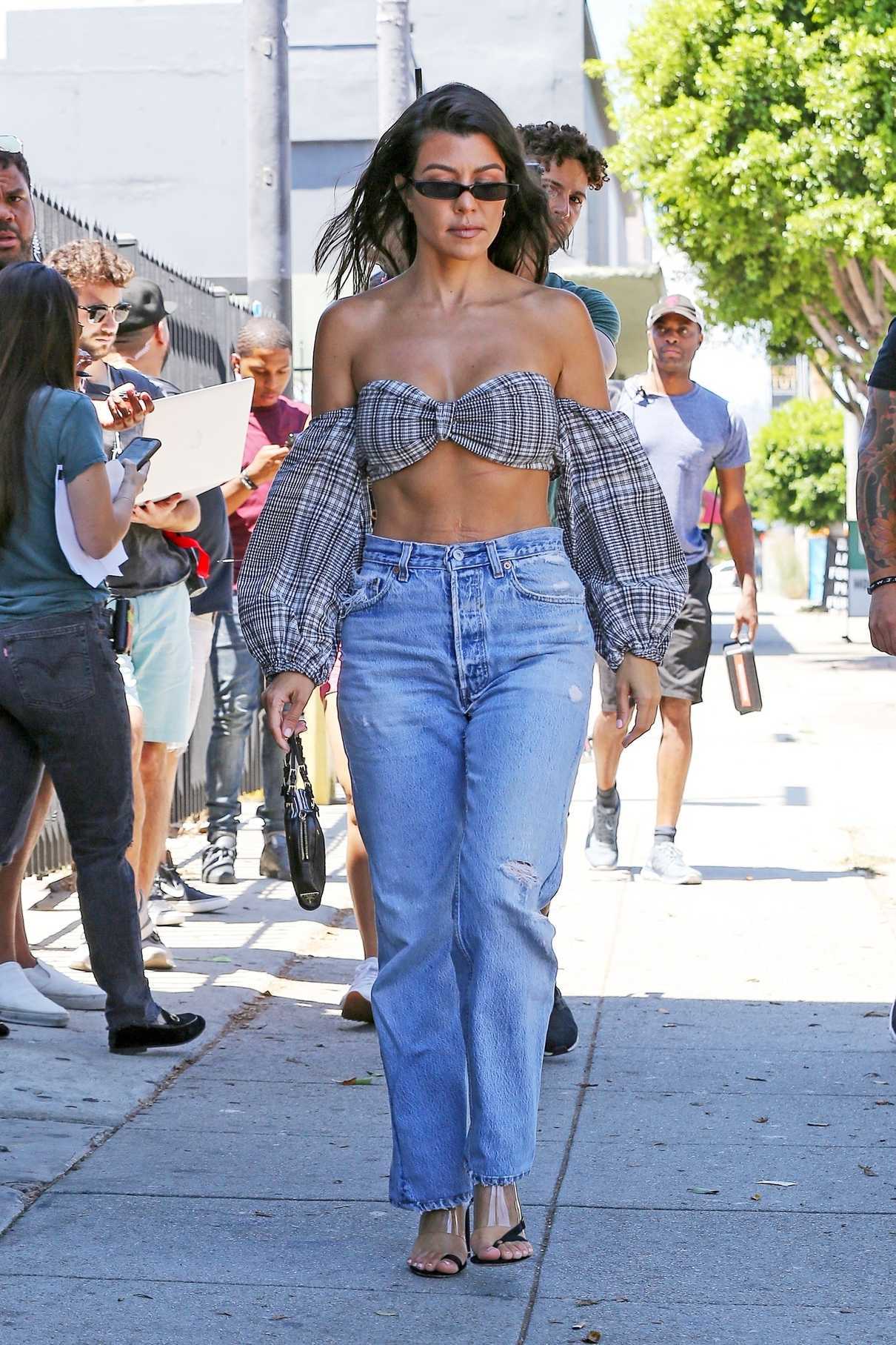 Kourtney Kardashian in a Ripped Blue Jeans
