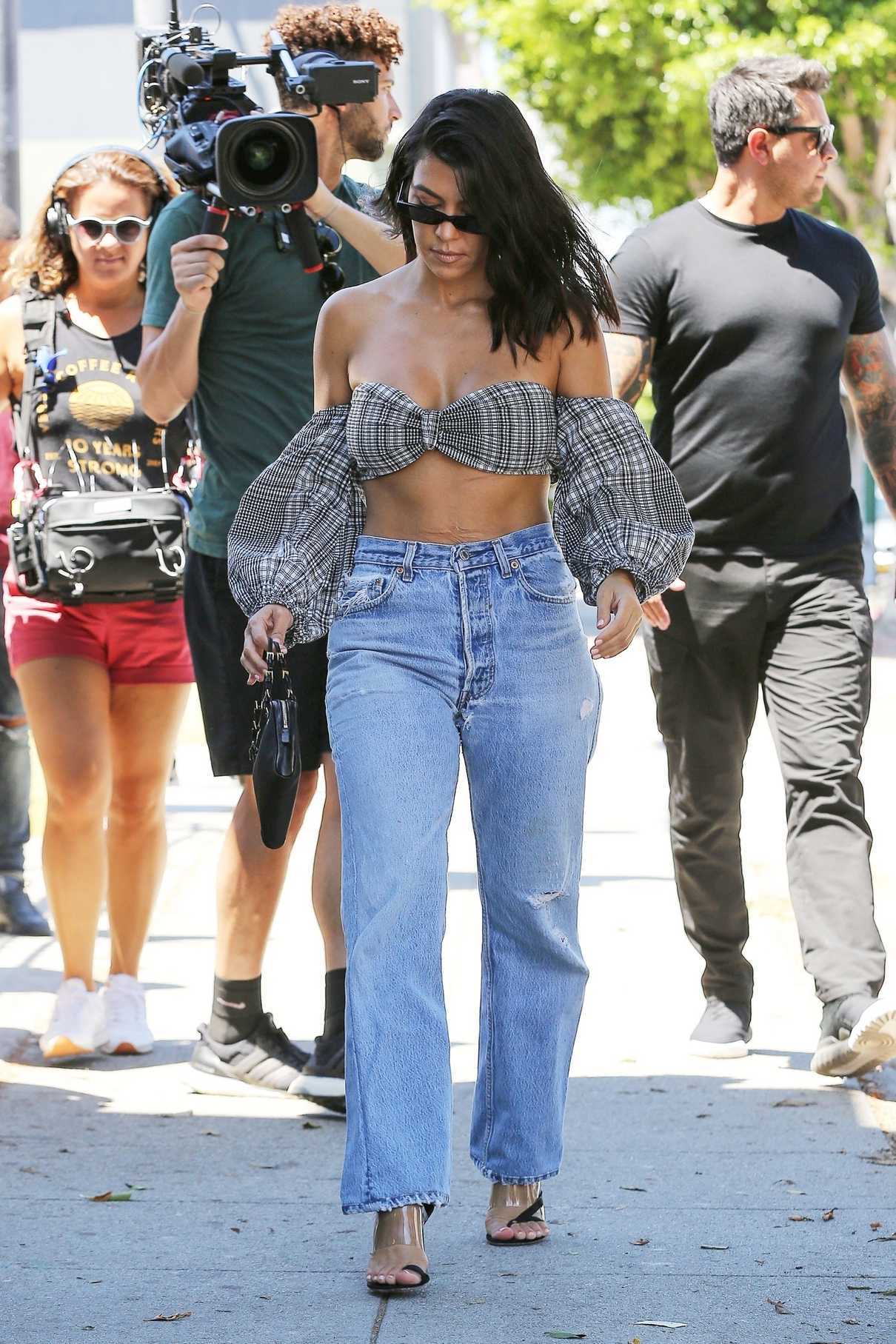 Kourtney Kardashian in a Ripped Blue Jeans