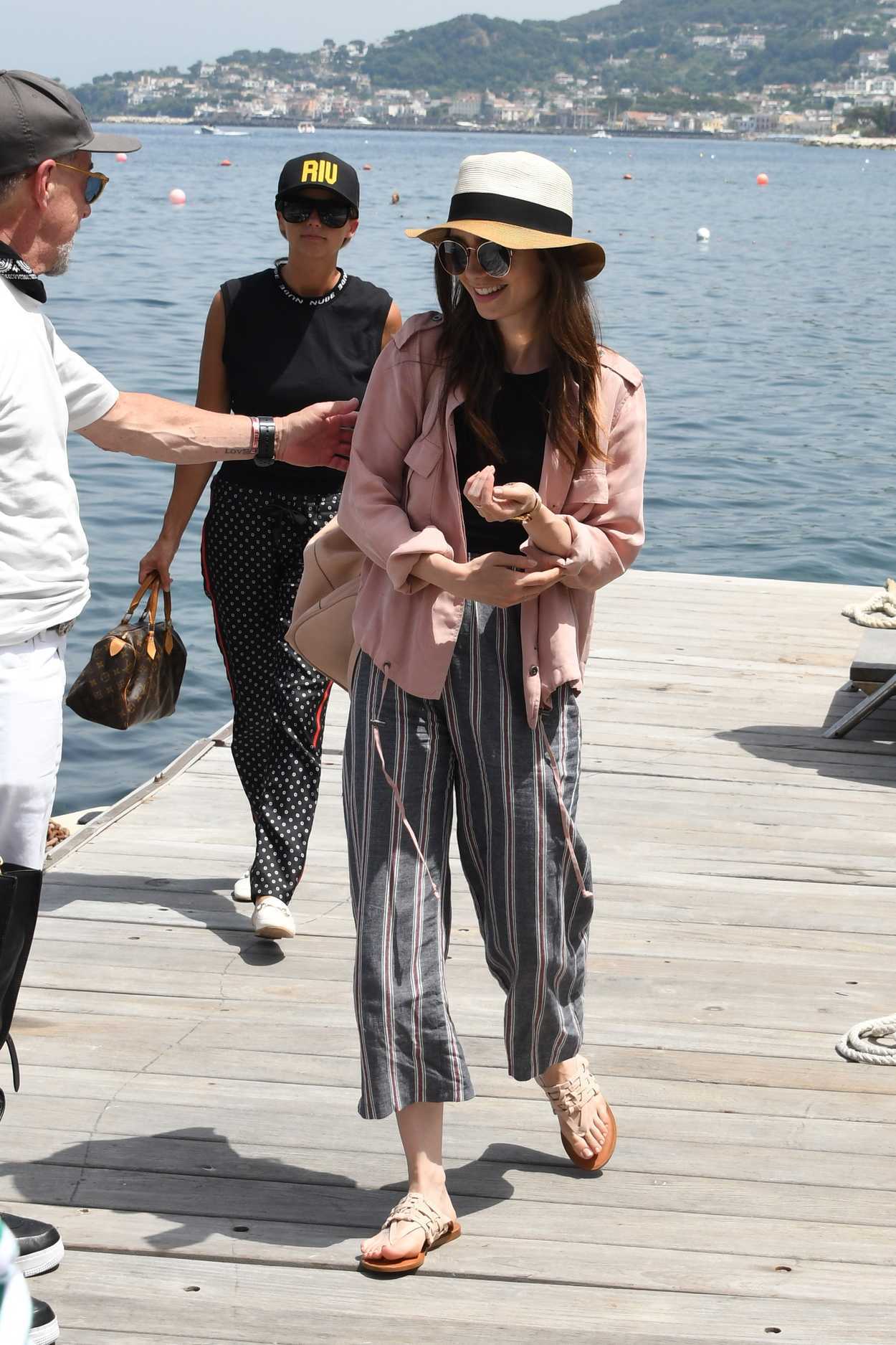 Lily Collins Wears a Pink Jacket as She Arrives at Hotel Regina Isabella in Ischia Porto 07/14/2018-2