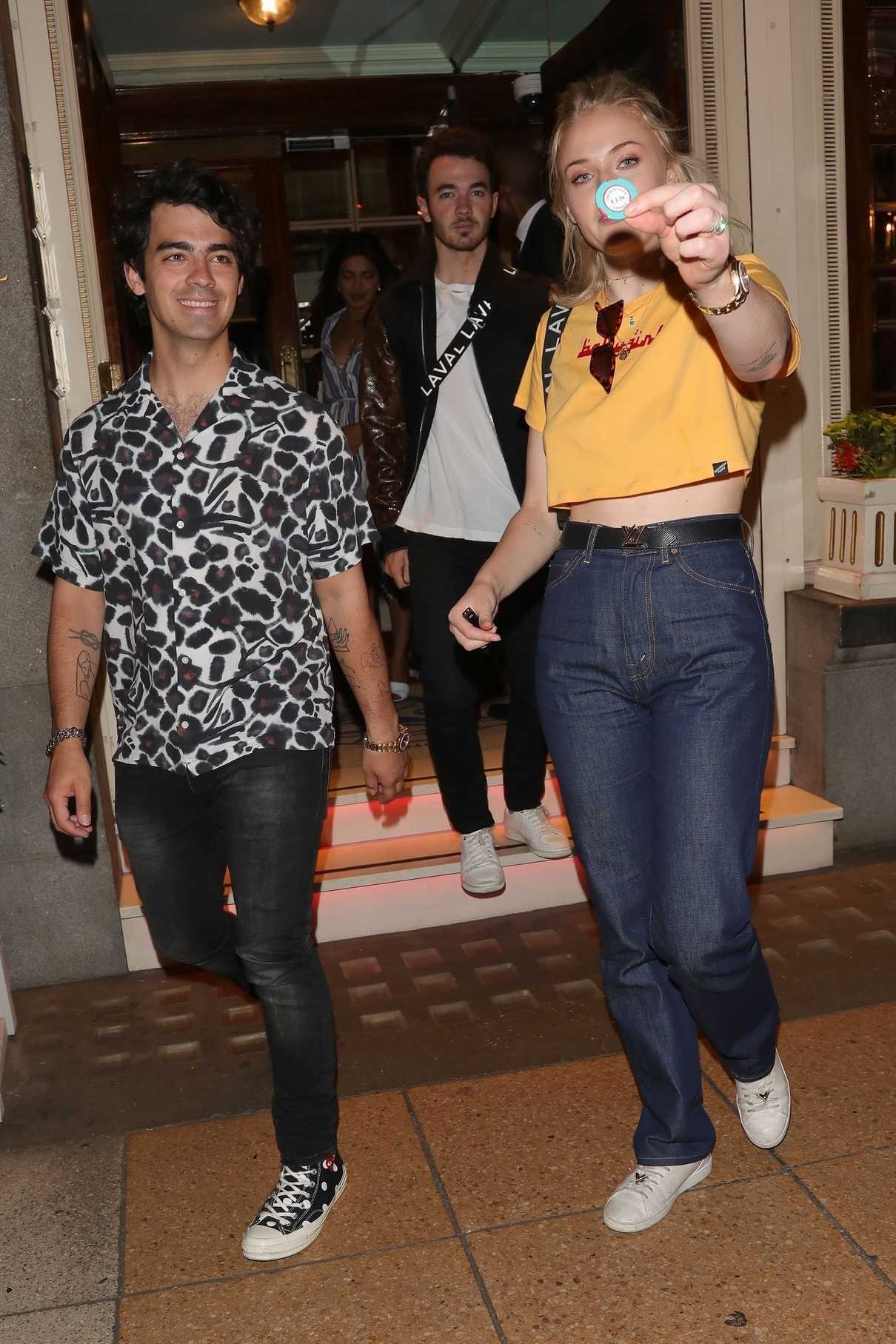 Sophie Turner Wears a Short Yellow T-Shirt as She Leaves the Ritz Club in London 07/17/2018-2