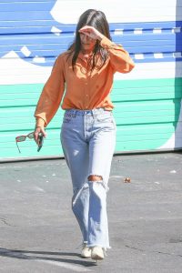 Kourtney Kardashian ia an Orange Blouse