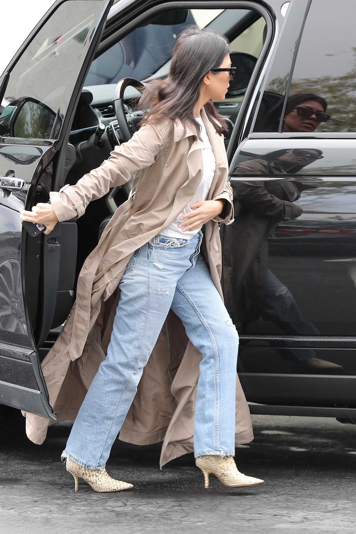 Kourtney Kardashian in a Beige Trench Coat Attends Church Services in