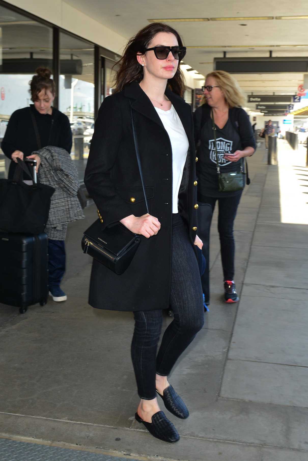 Anne Hathaway in a Black Coat Arrives at LAX Airport in LA 04/03/2019-2 ...