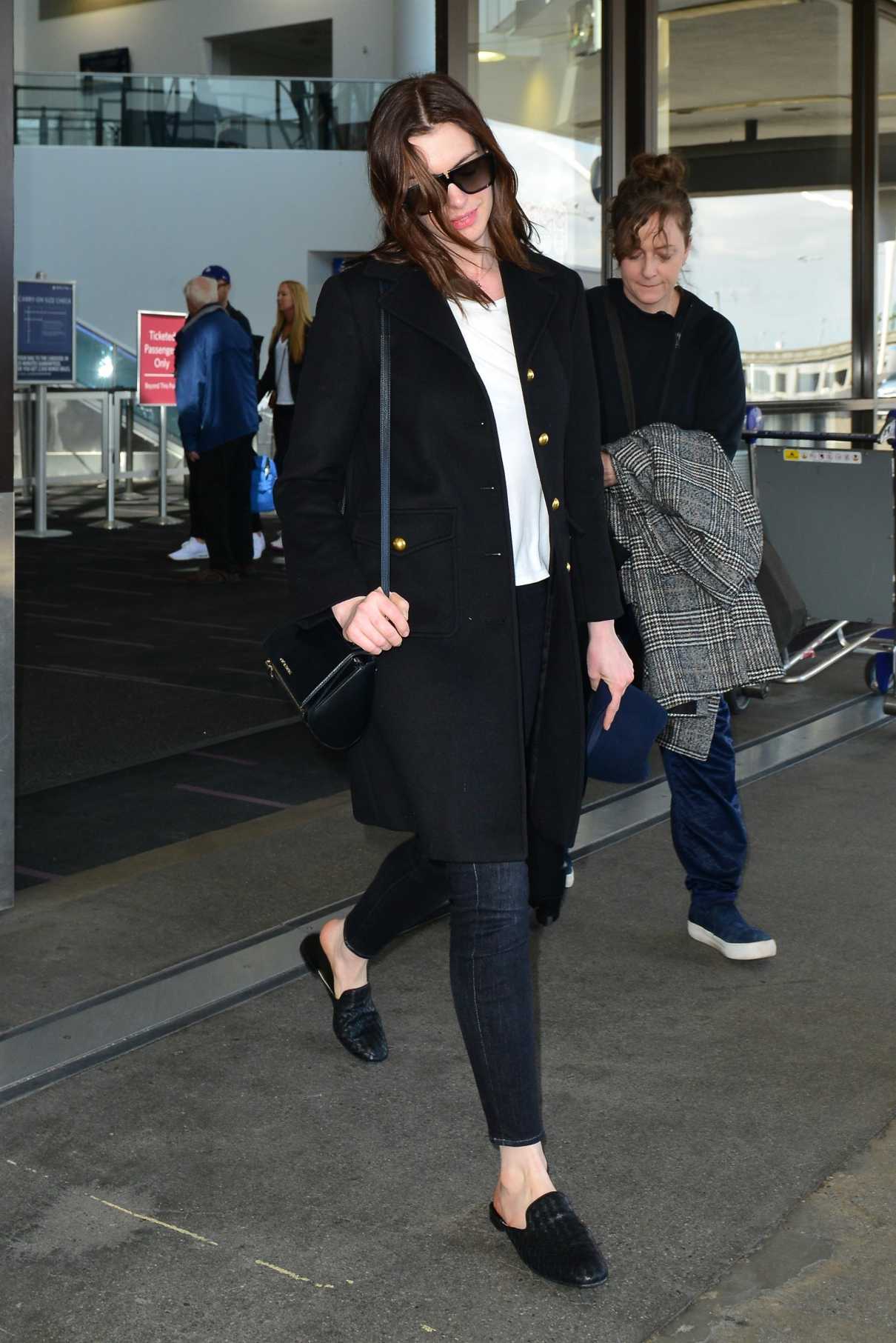 Anne Hathaway in a Black Coat Arrives at LAX Airport in LA 04/03/2019-3 ...