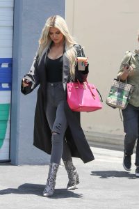 Khloe Kardashian in a Black Trench Coat