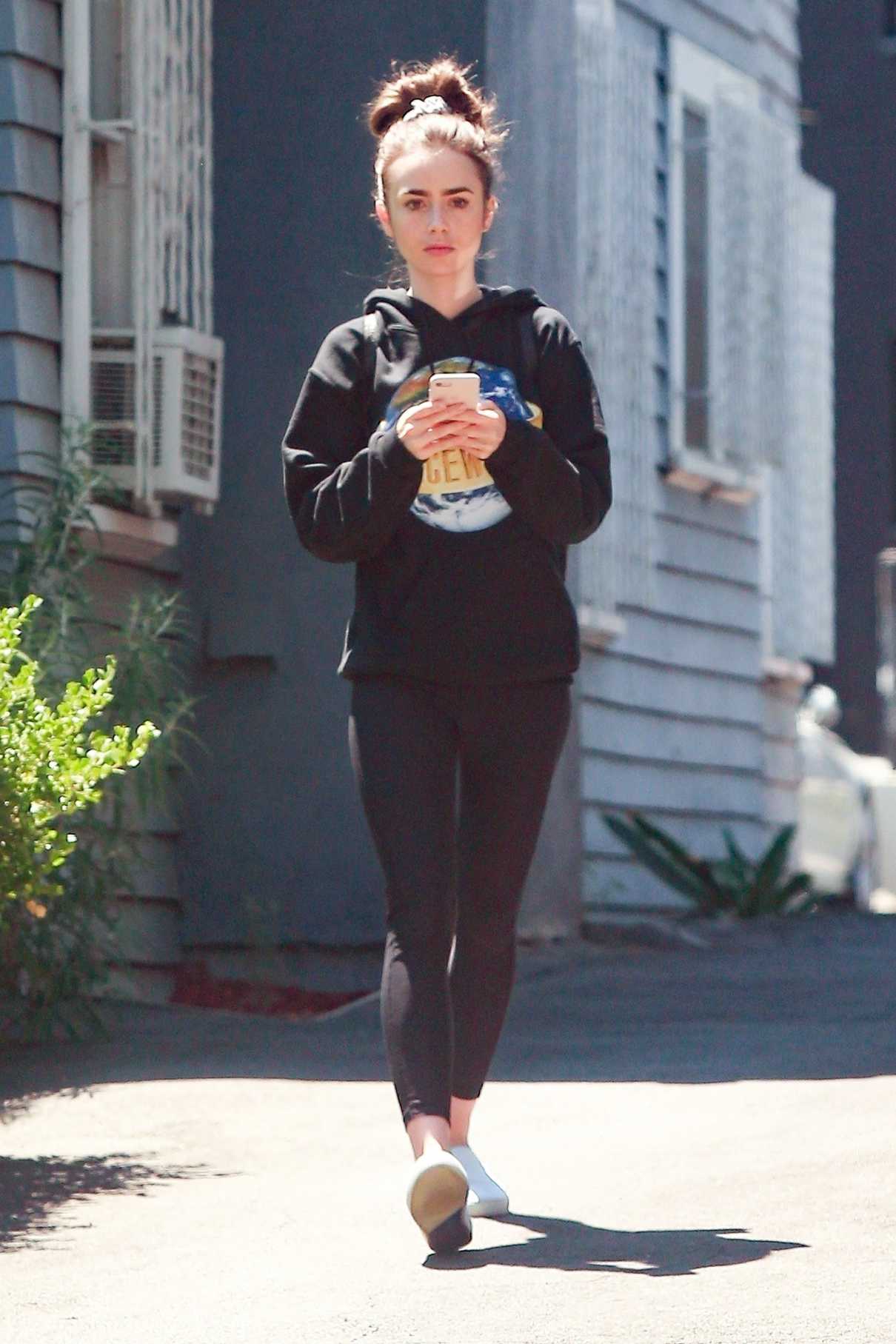 Lily Collins in a Black Hoody