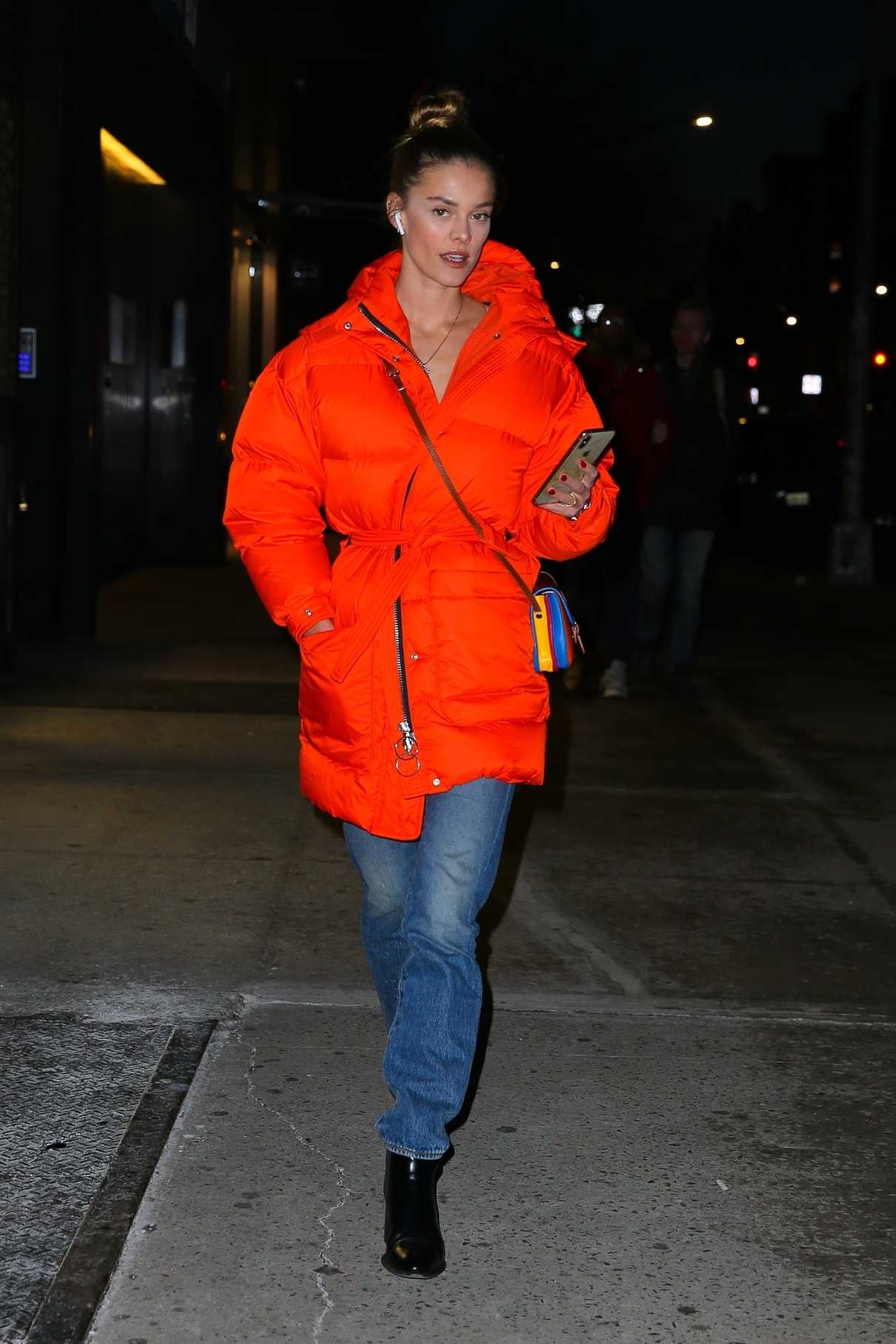 Nina Agdal in an Orange Puffer Coat