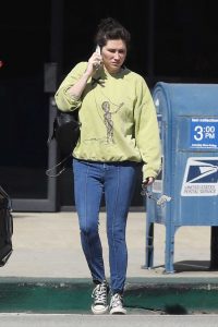 Kesha in a Yellow Sweatshirt