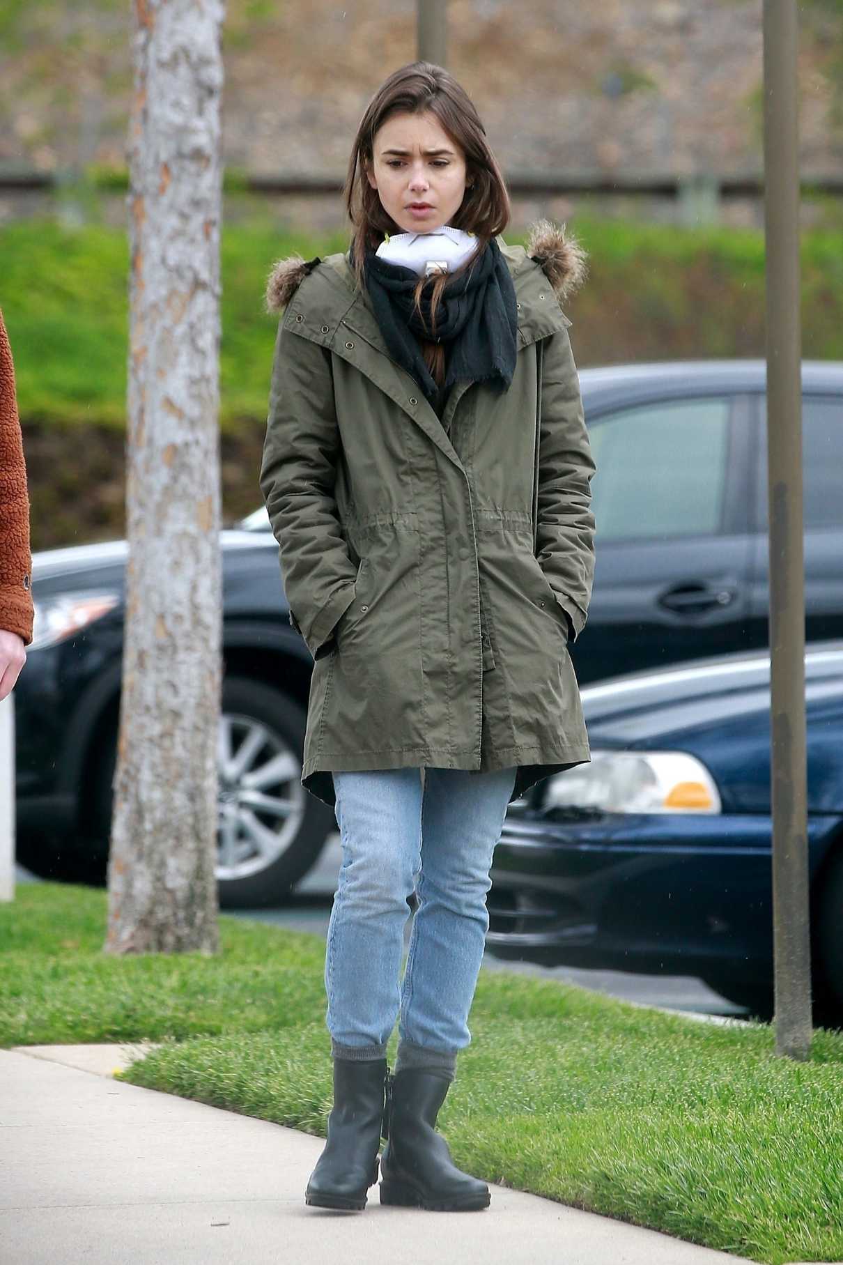 Lily Collins in a Black Rubber Boots