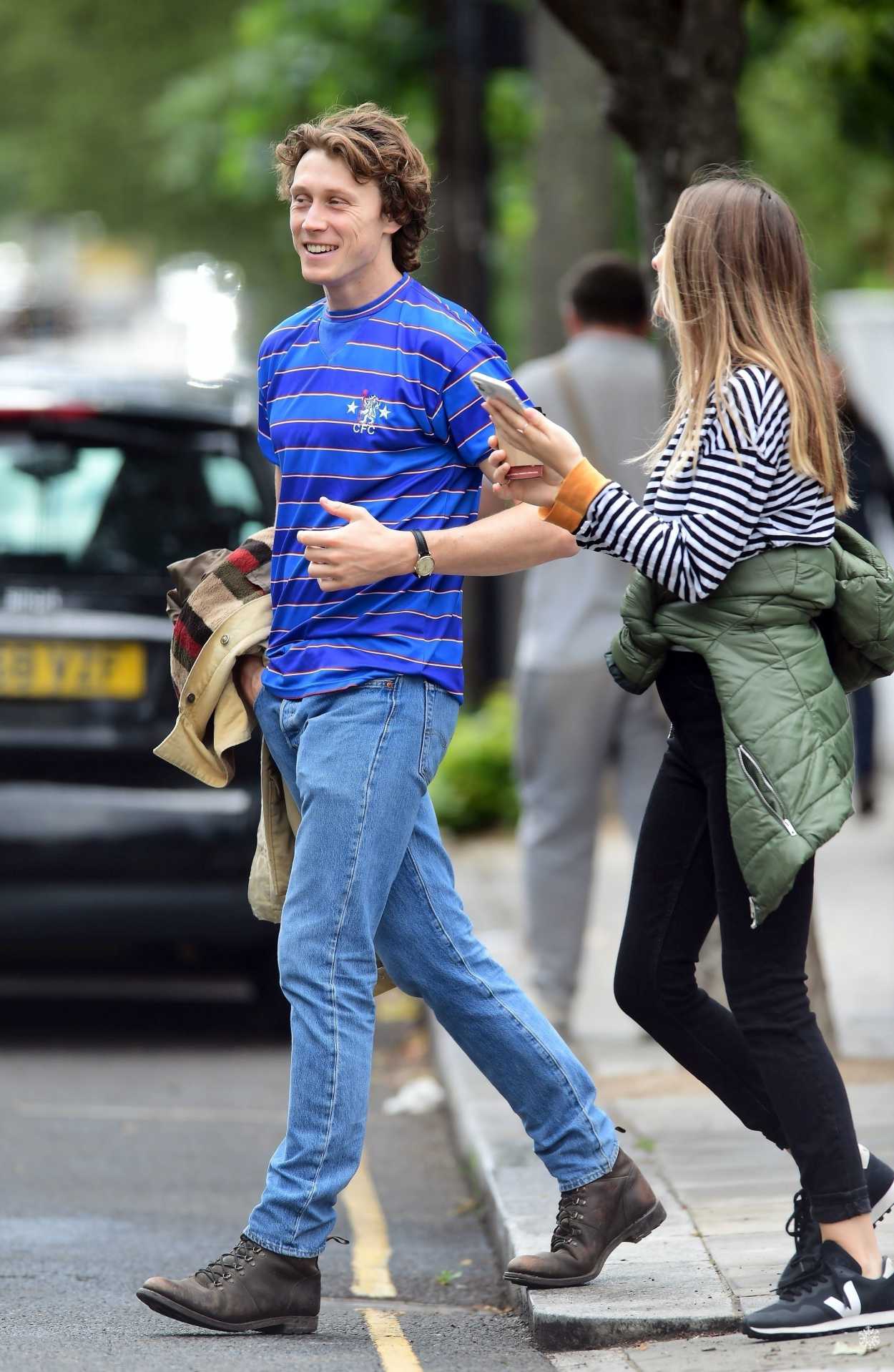 George MacKay in a Blue Striped T-Shirt Was Seen Out with His Girlfriend in...