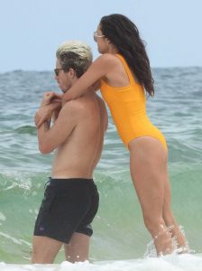 Nina Dobrev in an Orange Swimsuit