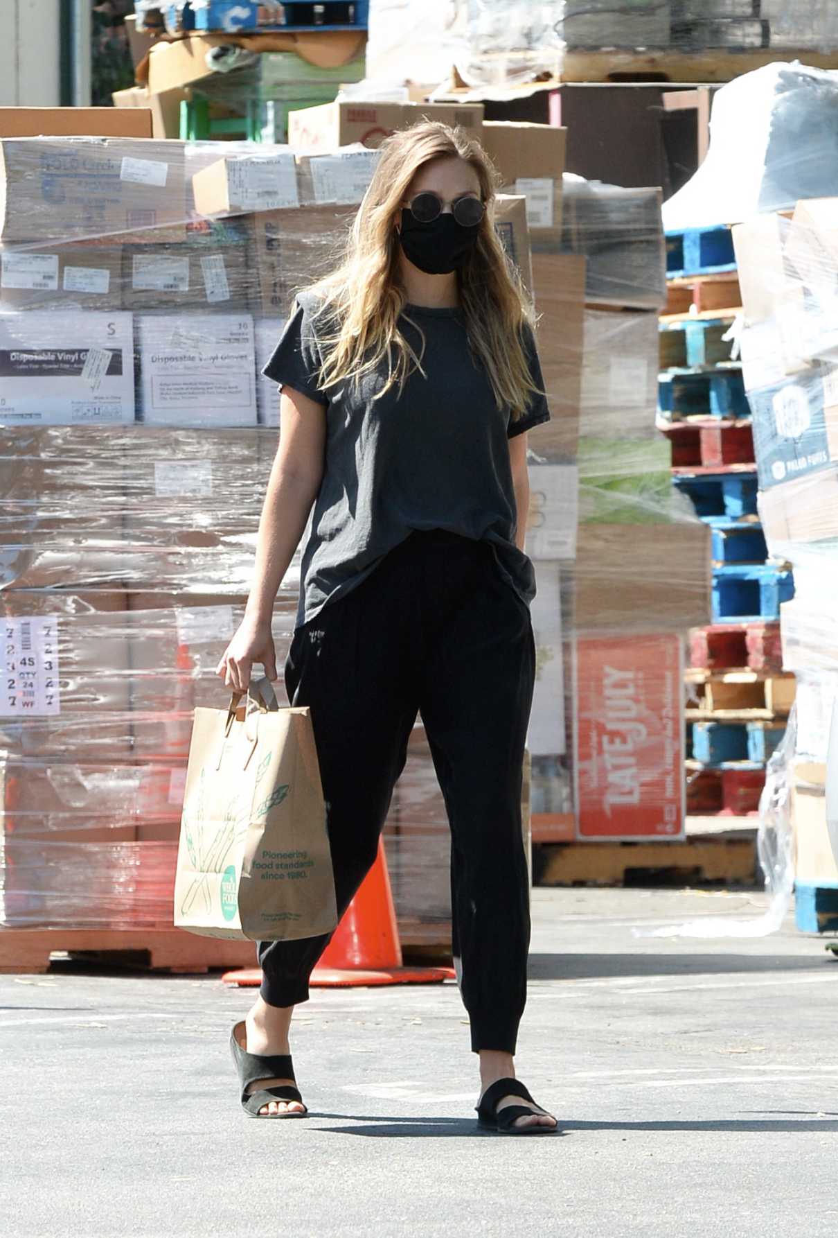 Elizabeth Olsen in a Black Protective Mask