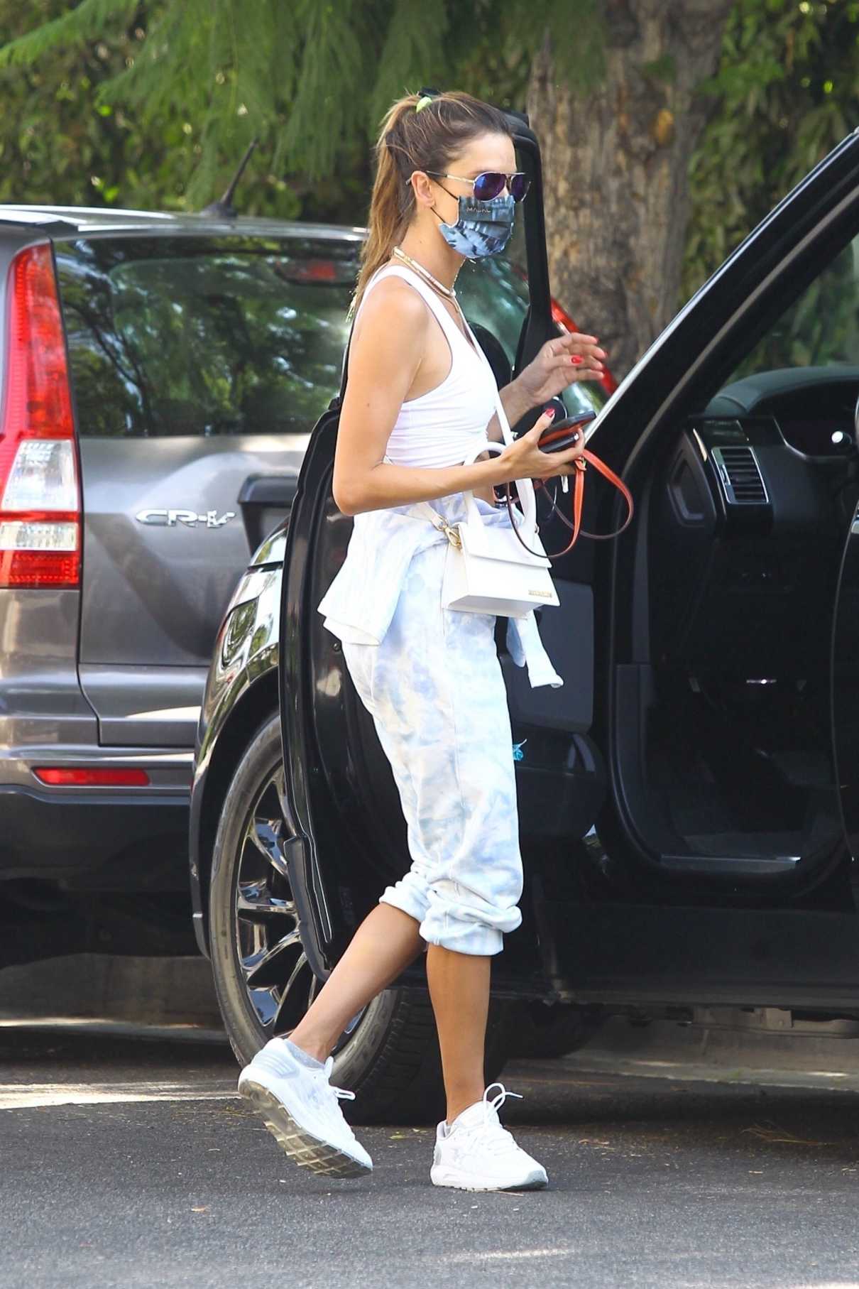 Alessandra Ambrosio in a White Sports Bra Arrives at a Friend’s House ...