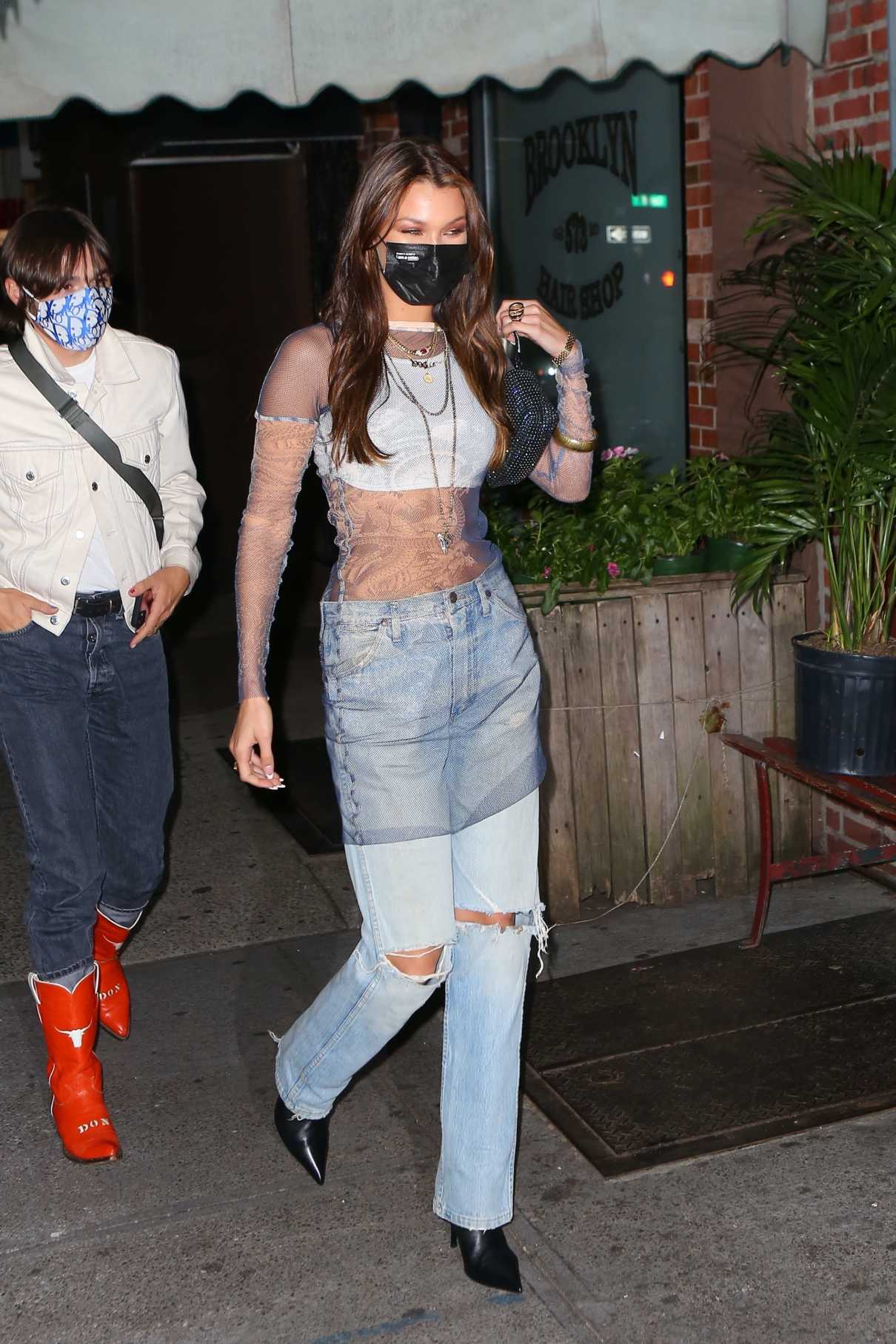 Bella Hadid in a Blue Ripped Jeans Heads to Her Pre-Birthday Dinner