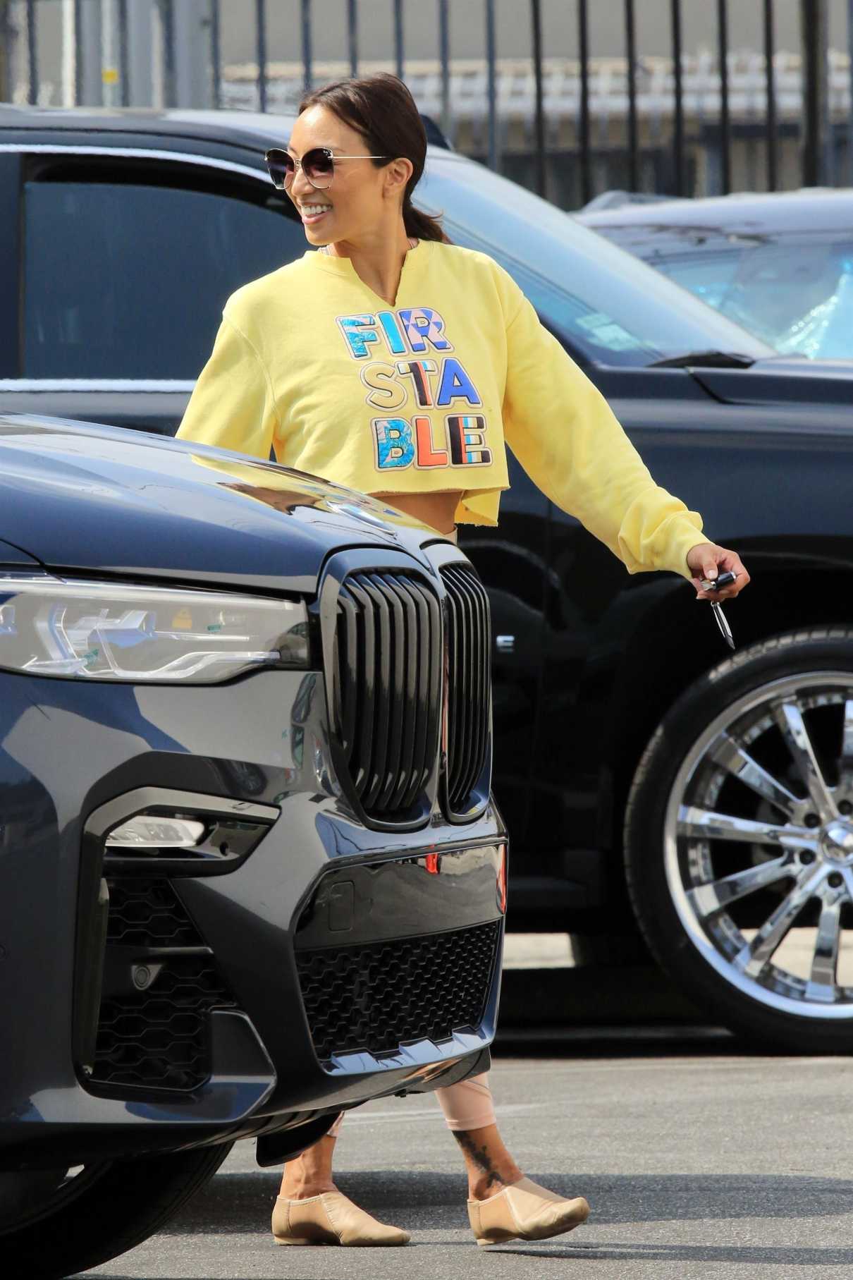 Jeannie Mai in a Yellow Cropped Sweatshirt