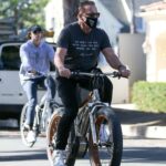 Arnold Schwarzenegger in a Black Tee Enjoys a Morning Bike Ride with His Children Patrick and Christina in Santa Monica 11/28/2020