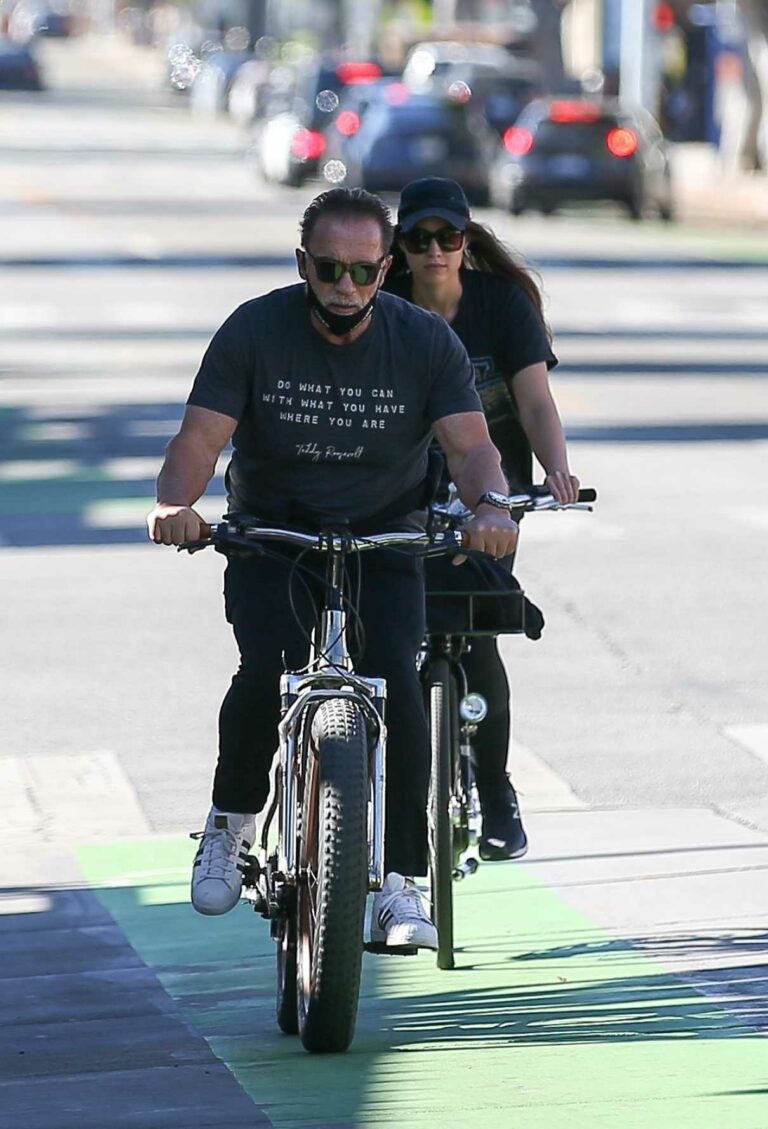 Arnold Schwarzenegger in a Black Tee Enjoys a Morning Bike Ride with