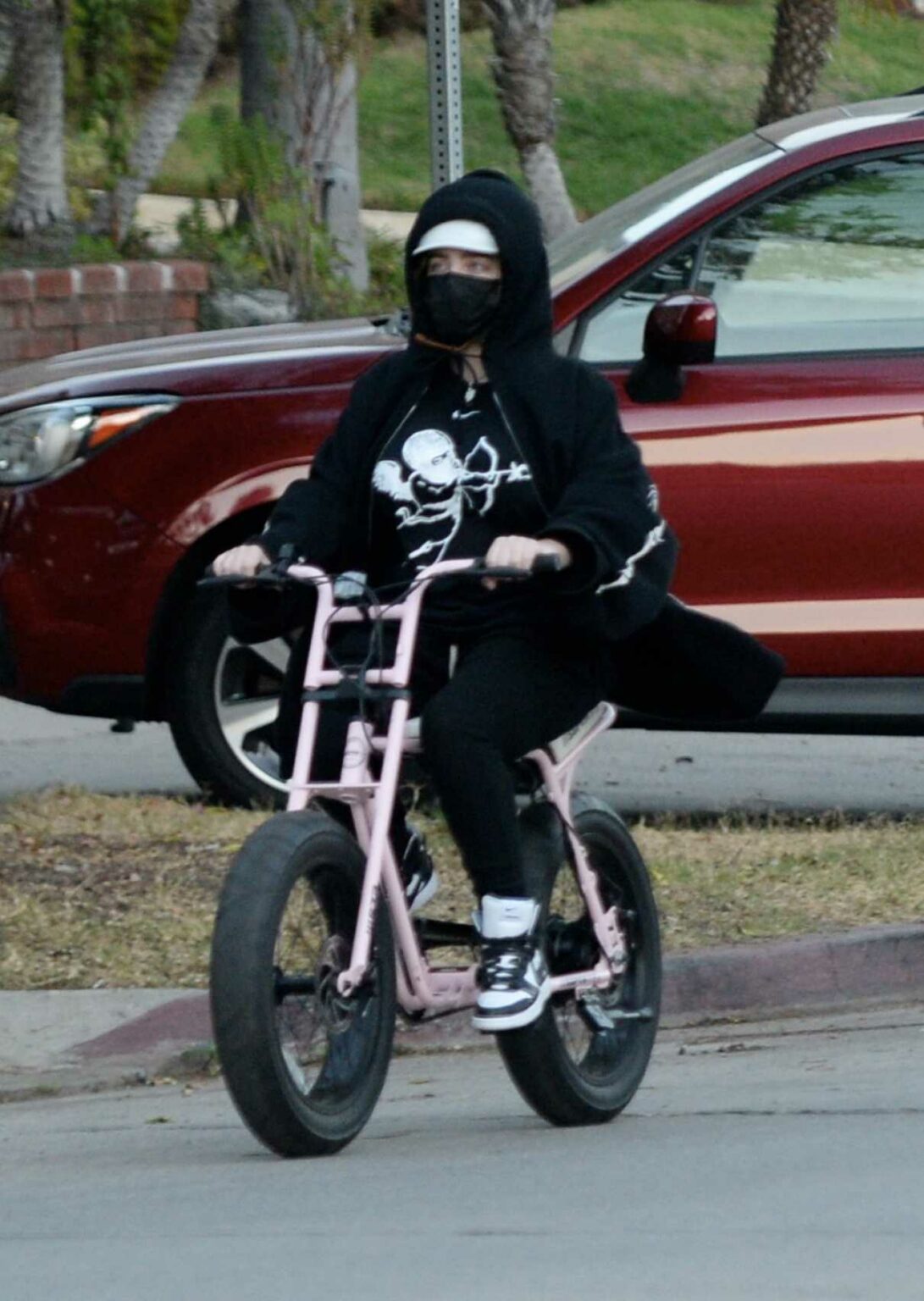 Billie Eilish in a Black Protective Mask Does a Bike Ride in Los
