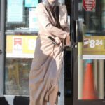 Miya Ponsetto in a Beige Trench Coat Fills Her Tank with Gas in Los Angeles 01/08/2021