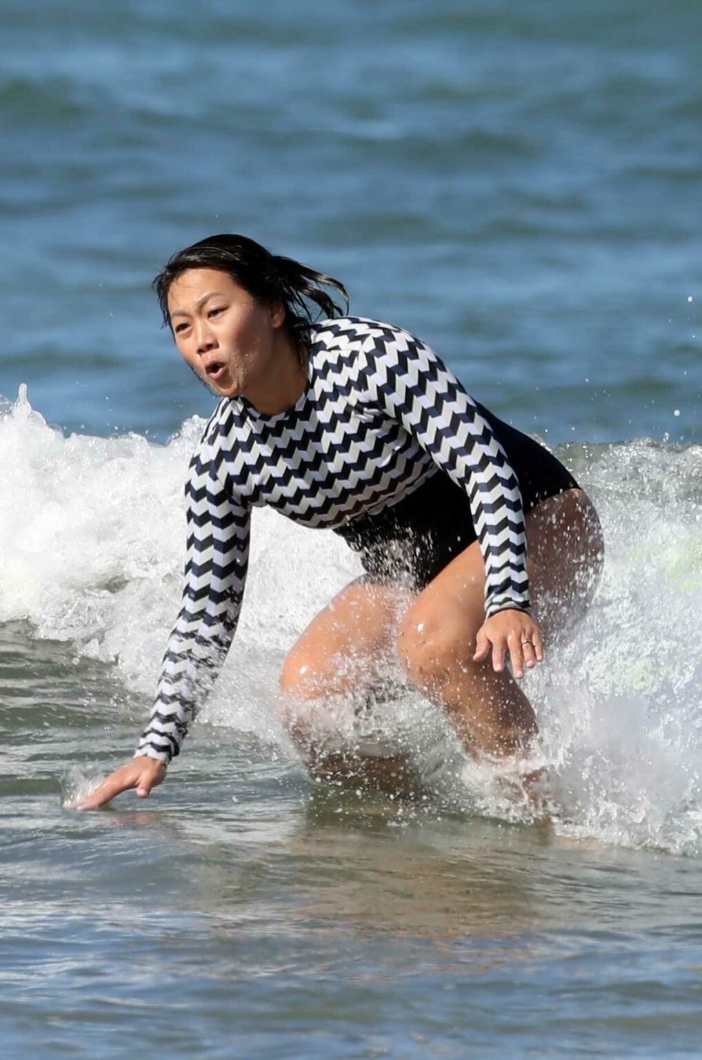 Priscilla Chan in a Black and White Swimsuit Hits the Waves in Hawaii