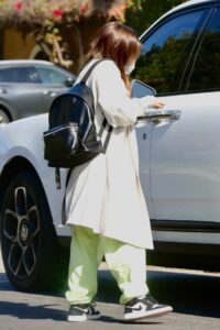 Addison Rae in a White Trench Coat