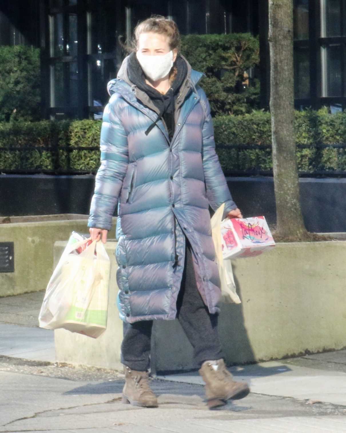 Britt Robertson in a Grey Puffer Coat