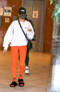 Hailey Bieber in an Orange Leggings