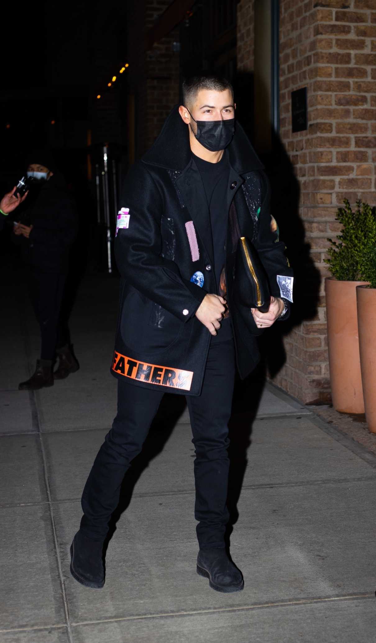 Nick Jonas in a Black Coat