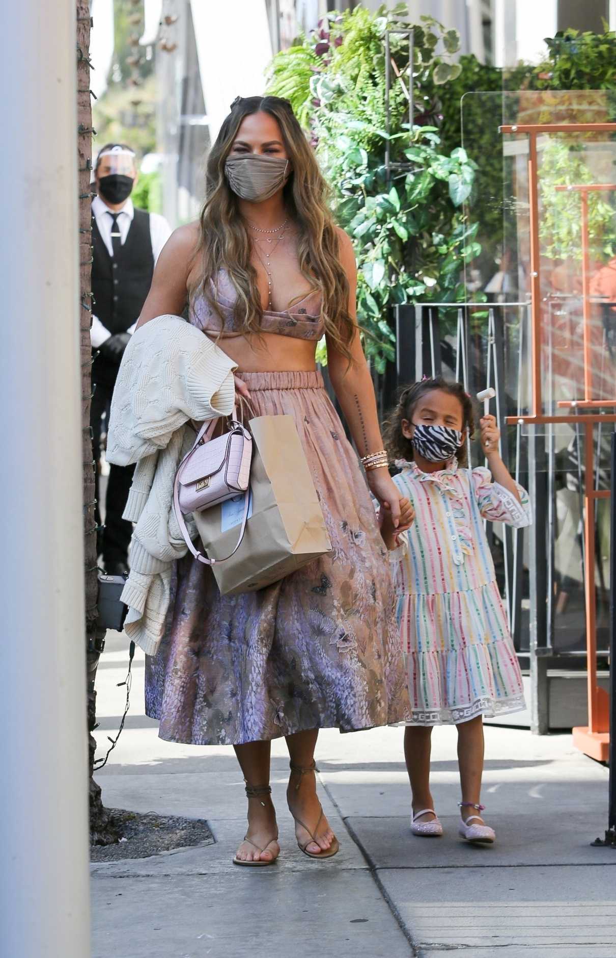 Chrissy Teigen in an Olive Protective Mask