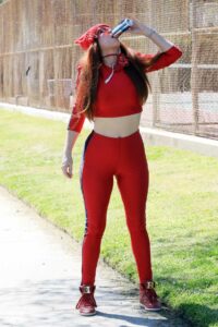 Phoebe Price in a Red Workout Ensemble