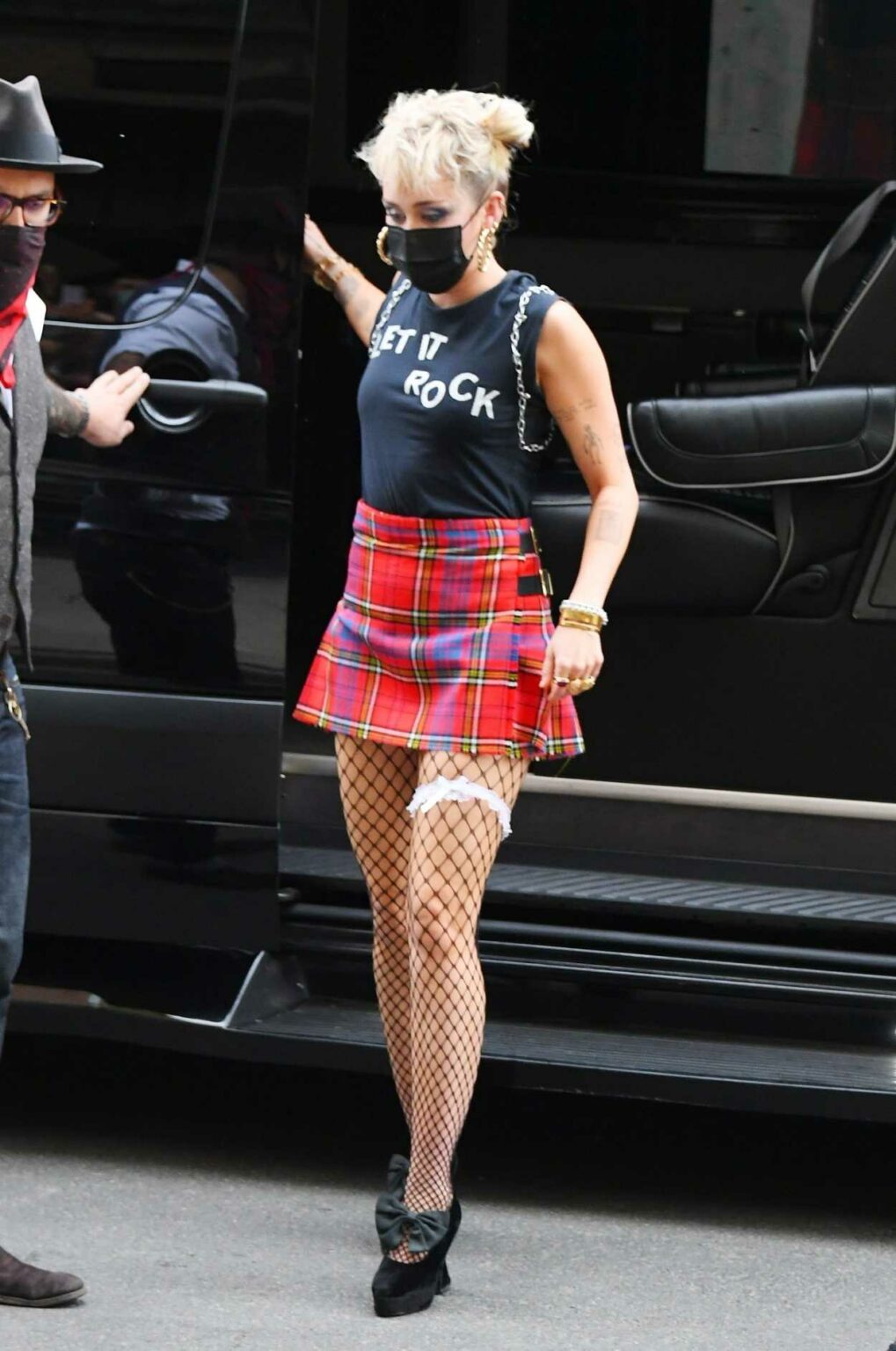 Miley Cyrus in a Red Plaid Mini Skirt Returns to Her Hotel After