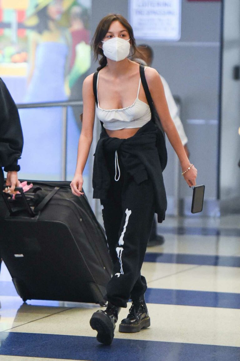 Olivia Rodrigo in a Protective Mask Arrives at JFK Airport in New York