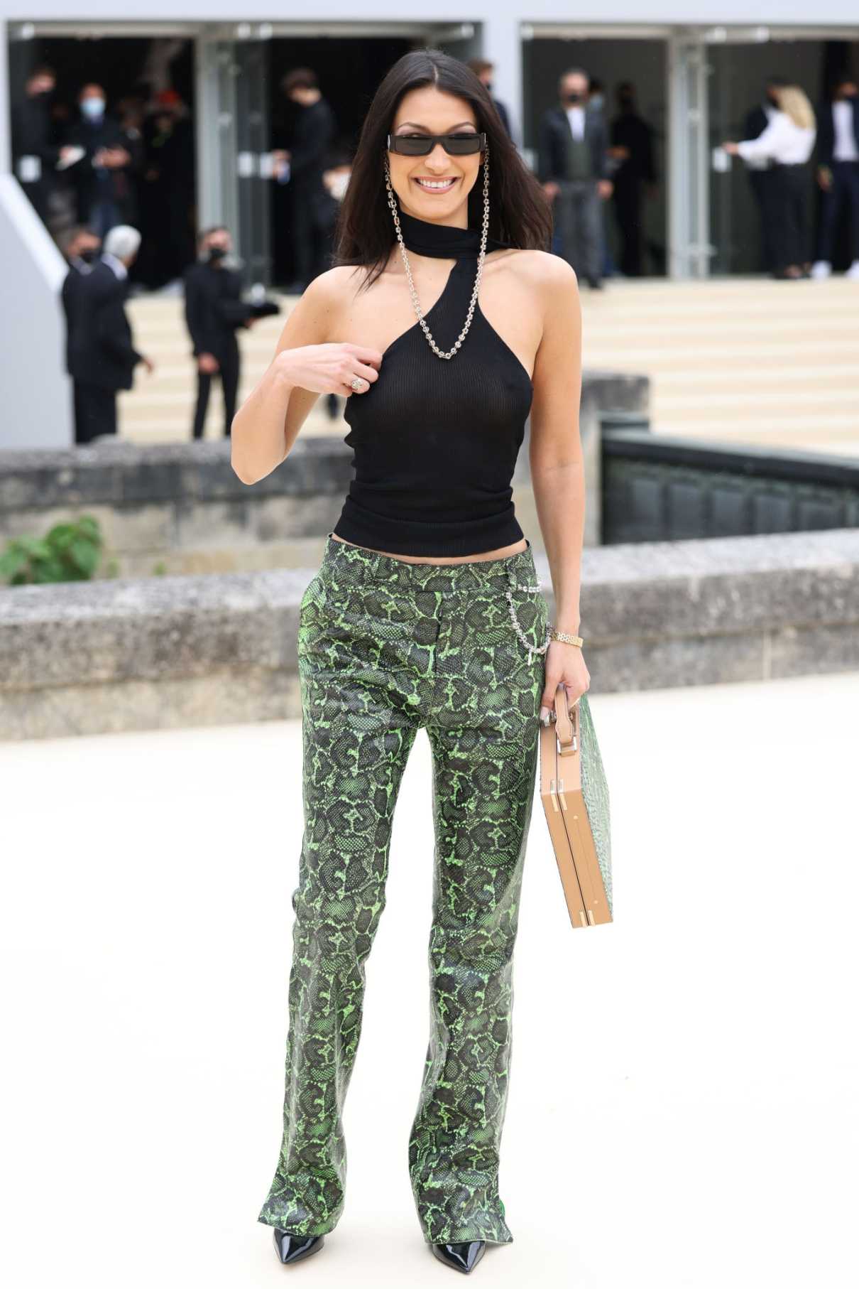 Bella Hadid in a Green Snakeskin Print Pants Arrives at 2022 Dior Homme ...