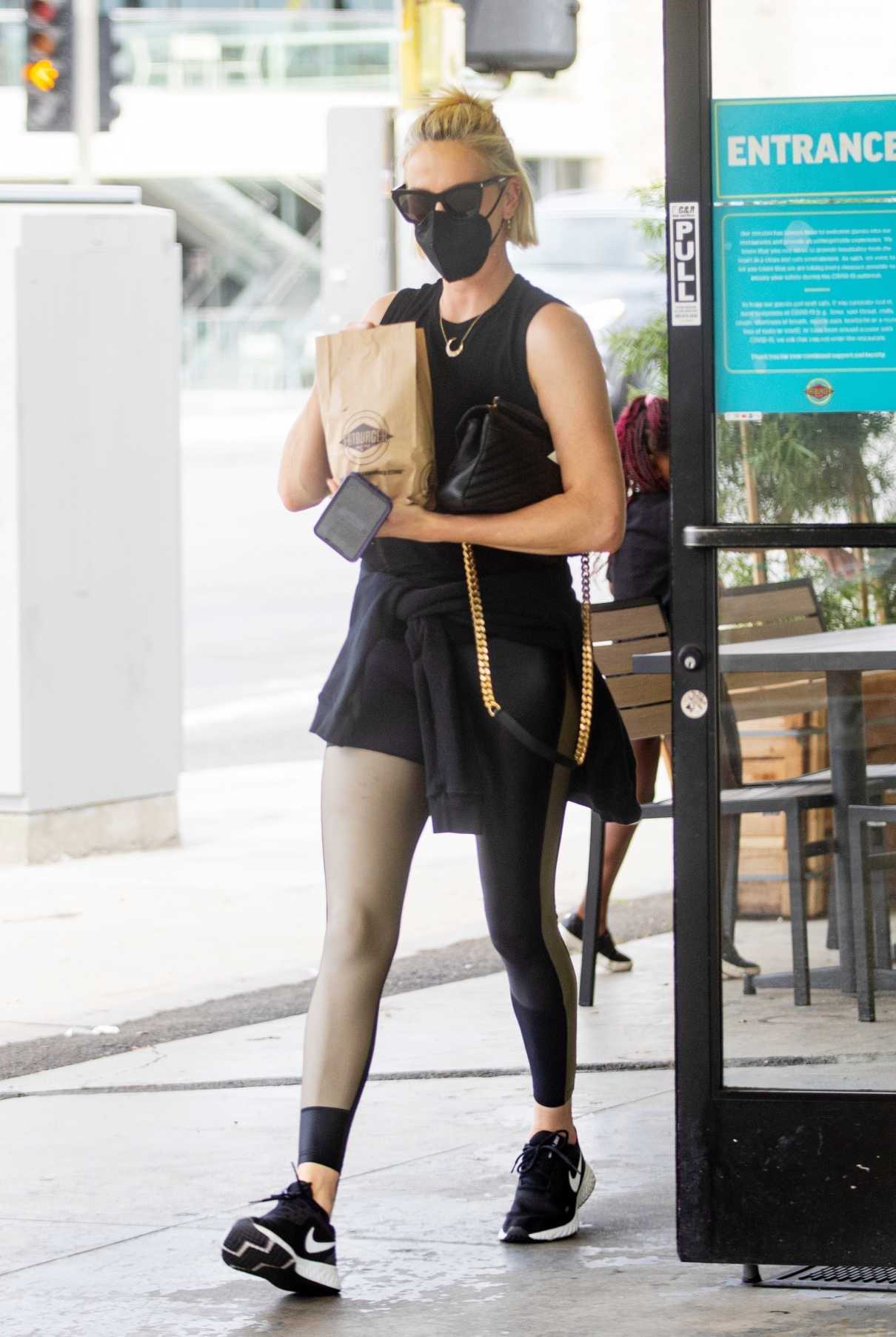 Charlize Theron in a Black Protective Mask