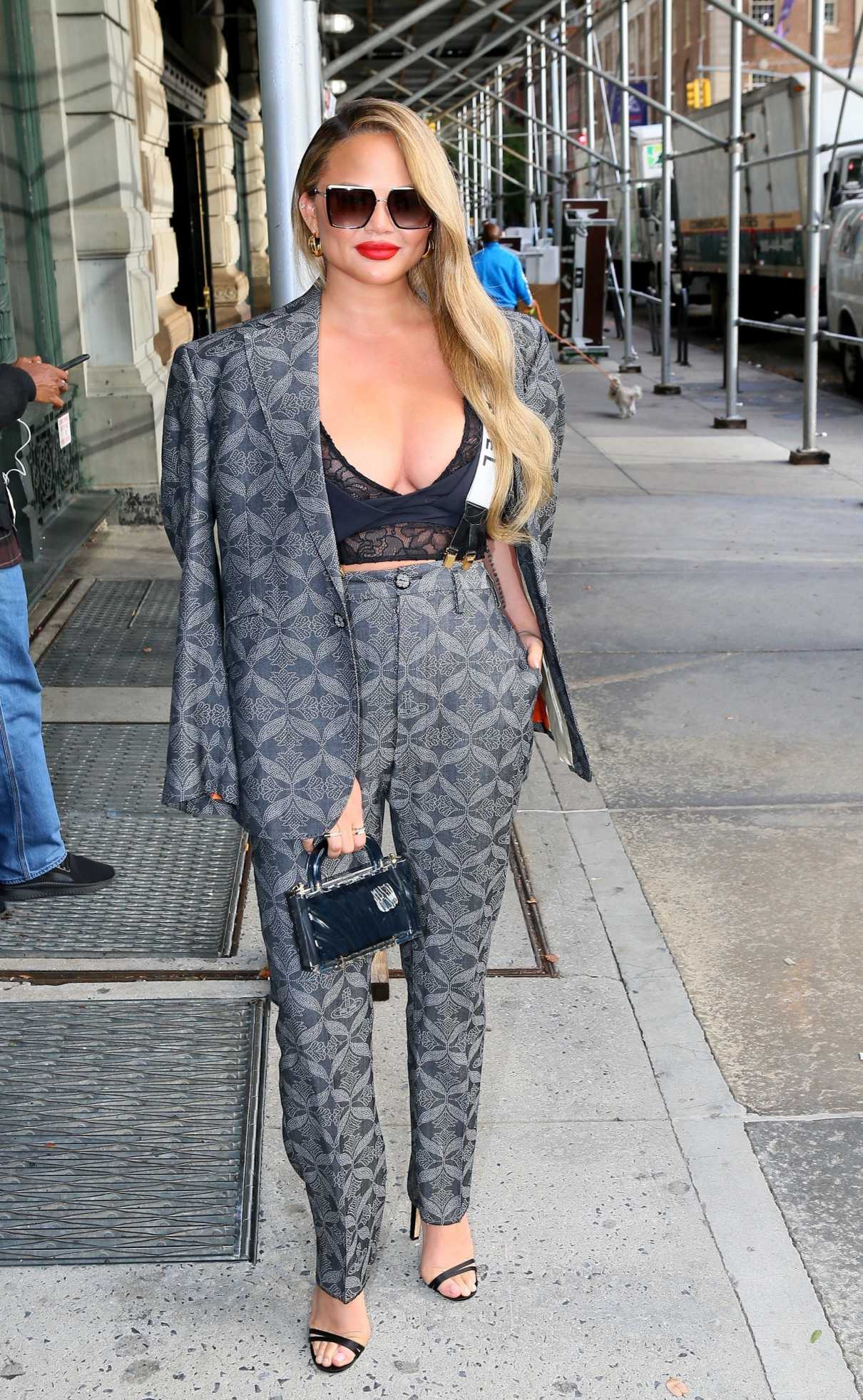 Chrissy Teigen in a Grey Patterned Pantsuit