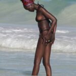 Adut Akech in a Black Bikini on the Beach in Tulum, Mexico 12/25/2021