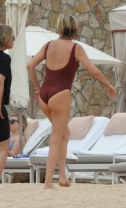 Charlize Theron in a Burgundy Color Swimsuit