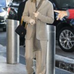 Miley Cyrus in a Beige Pantsuit Arrives at JFK Airport in New York 12/12/2021