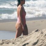 Chrissy Teigen in a Pink Swimsuit on the Beach in Malibu 02/21/2022