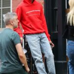 Evan Mock in a Red Hoodie on the Set of the Gossip Girl TV Series with Emily Alyn Lind in New York City 07/26/2022