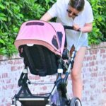 Mia Goth in Blue Daisy Duke Shorts Pushing Her Baby in a Pink Stroller Out in Pasadena 07/24/2022