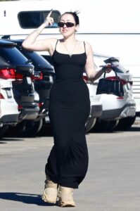 Noah Cyrus in a Black Form Fitting Dress
