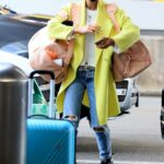 Kate Beckinsale in a Neon Yellow Coat Arrives at LAX Airport in Los Angeles 10/15/2022