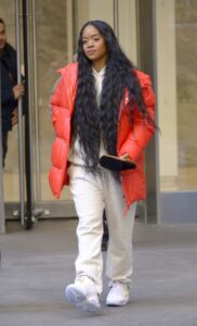 H.E.R. in a Red Puffer Jacket