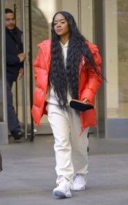 H.E.R. in a Red Puffer Jacket