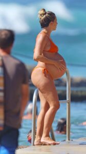 Renee Bargh in an Orange Bikini