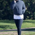 Katherine Schwarzenegger in a Black Cap Chats on the Phone During a Morning Walk in Pacific Palisades 04/07/2023